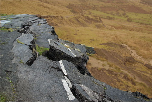 broken road set against brown dirt